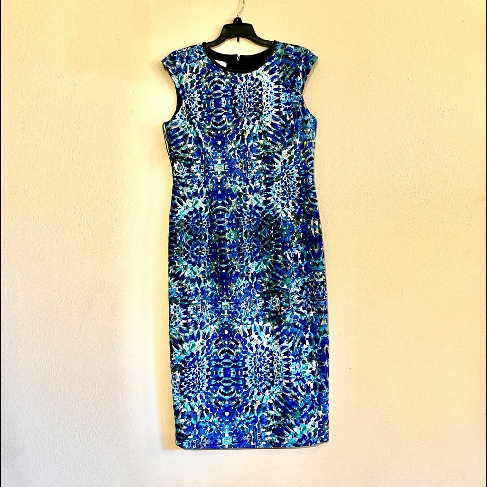 Blue floral with leather like neckline trim.